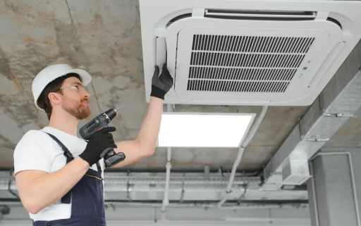 handsome-young-man-electrician-installing-air-cond